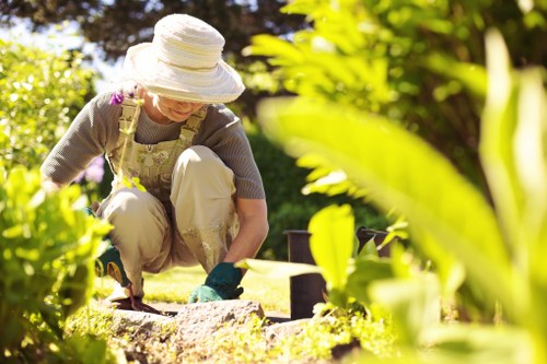 Gardener working in a Battersea garden near terraced houses